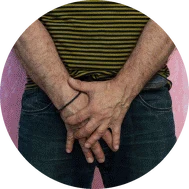 A man standing with hands clasped